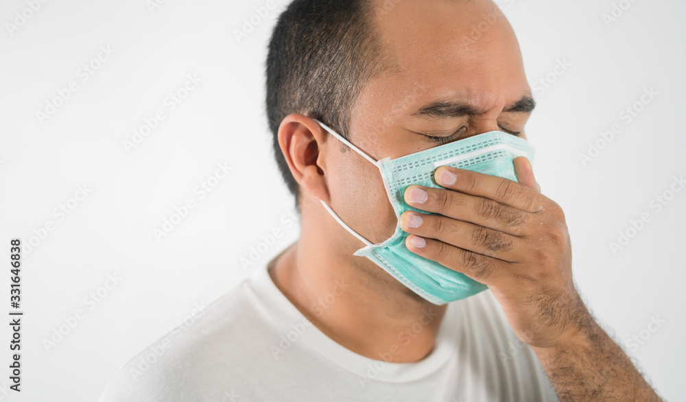 The young man had a cold and a fever. He wearing  protection mask. coronavirus or covid 19 concept.
