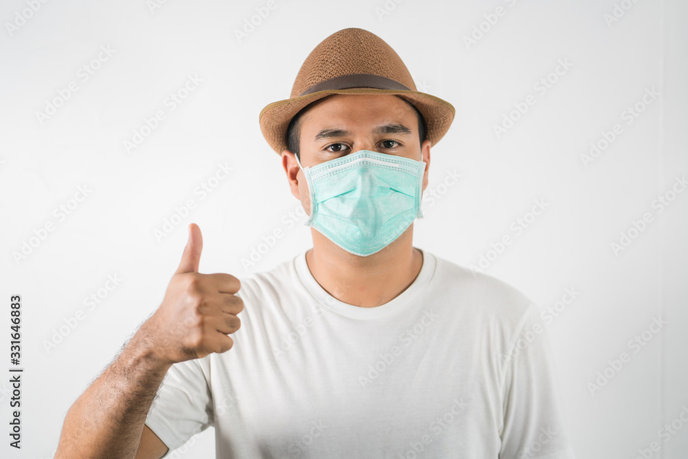 The young man had a cold and a fever. He wearing protection mask. coronavirus or covid 19 concept. The young man had a cold and a fever. He wearing protection mask. coronavirus or covid 19 concept.