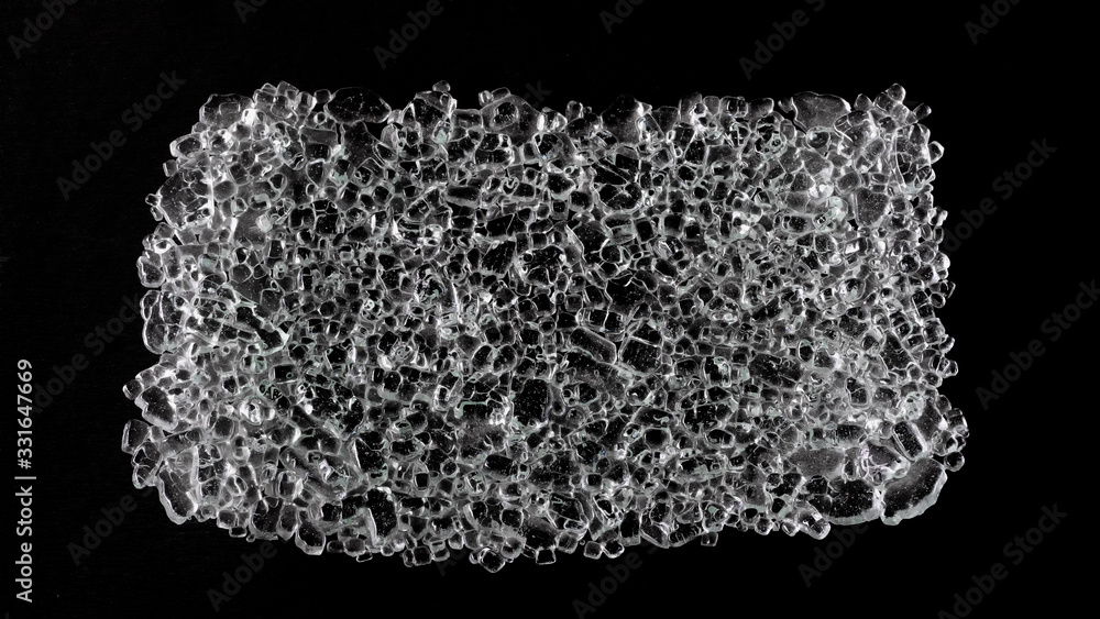 Black ice. Texture of melted pieces of ice on a black background. Abstraction and minimalism. Black ice. Texture of melted pieces of ice on a black background. Abstraction and minimalism.