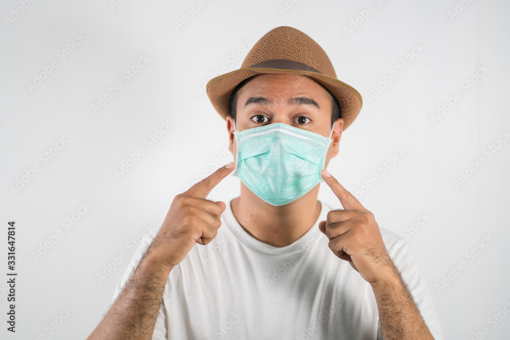 The young man had a cold and a fever. He wearing protection mask. coronavirus or covid 19 concept. The young man had a cold and a fever. He wearing protection mask. coronavirus or covid 19 concept.