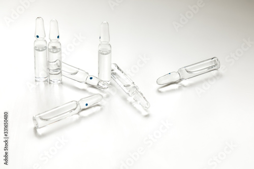 Glass ampoules with medicine on a white background. The place for an inscription