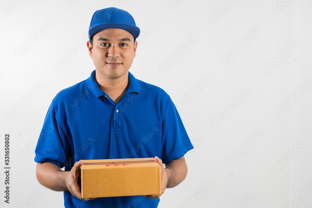 Blue Delivery handsome asian man holding parcel cardboard box on isolated white background. Blue Delivery handsome asian man holding parcel cardboard box on isolated white background.