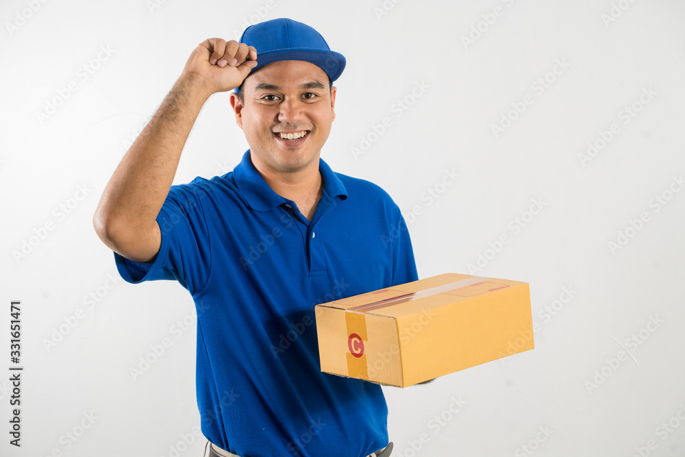 Blue Delivery handsome asian man holding parcel cardboard box on isolated white background. Blue Delivery handsome asian man holding parcel cardboard box on isolated white background.