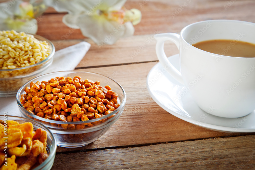 Close-up of fried snacks in bowls with cup of tea
Close-up of fried snacks in bowls with cup of tea