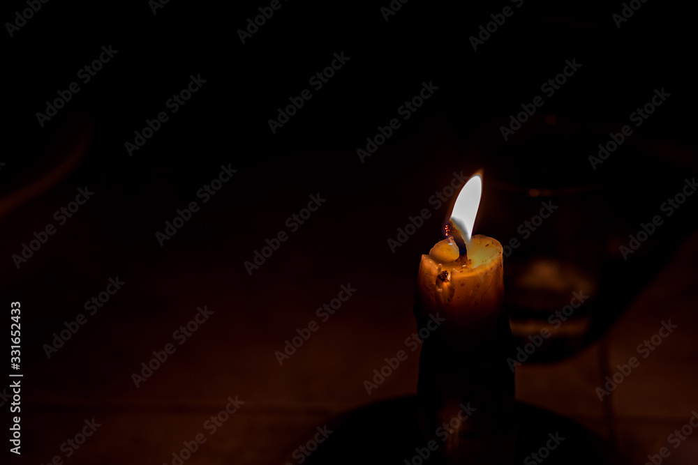 Candlelight with a black background. Concept of light in darkness.