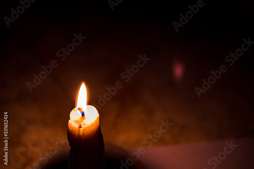 Candle lights against dark background. Concept of light in darkness in horizontal design