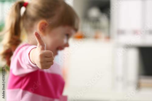 Little girl show approve or OK sign with her arm closeup
