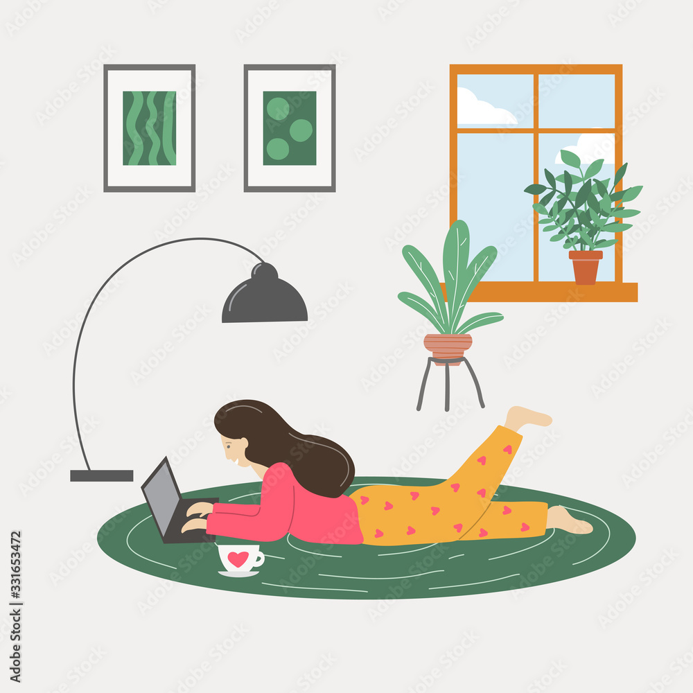 Fototapeta premium Girl lying on the floor and working on laptop at home.