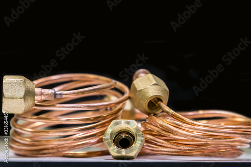 copper tube is rolled up for connection, the background is copper