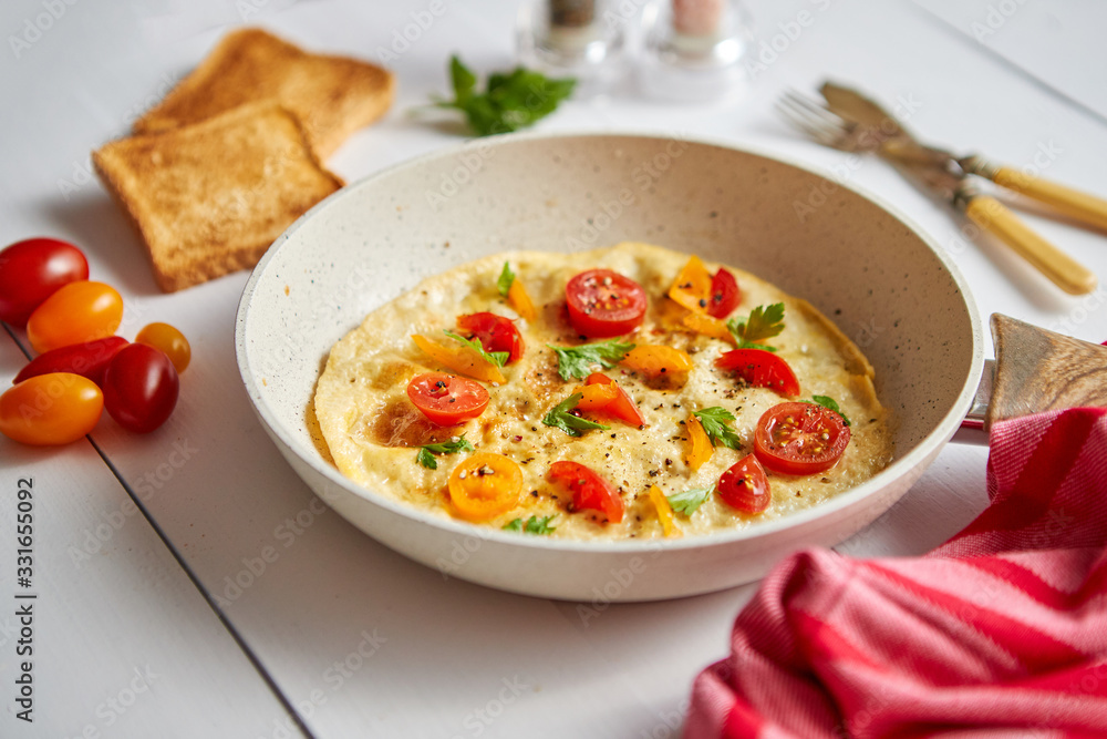Tasty homemade classic omelet with cherry tomatoes Tasty homemade classic omelet with cherry tomatoes