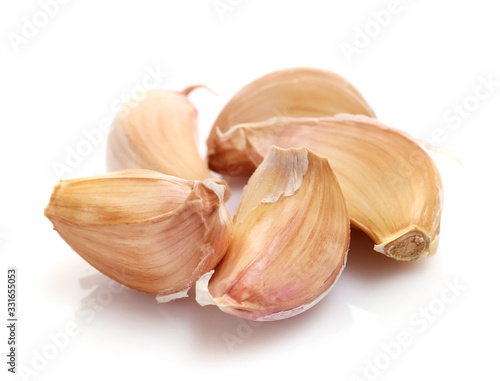 Garlic cloves isolated on white background © LumenSt