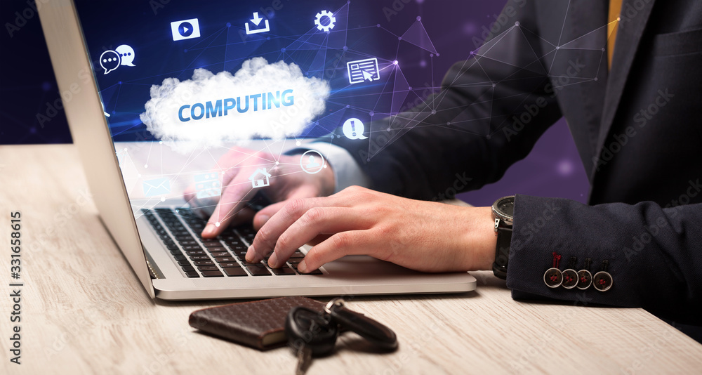 Businessman working on laptop with COMPUTING inscription, modern technology concept Businessman working on laptop with COMPUTING inscription, modern technology concept