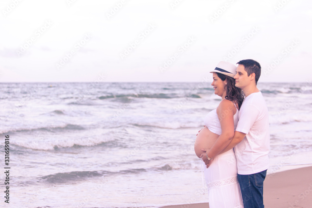Valencia,Spain, 3,6,2015: pregnant couple outdoors Valencia,Spain, 3,6,2015: pregnant couple outdoors