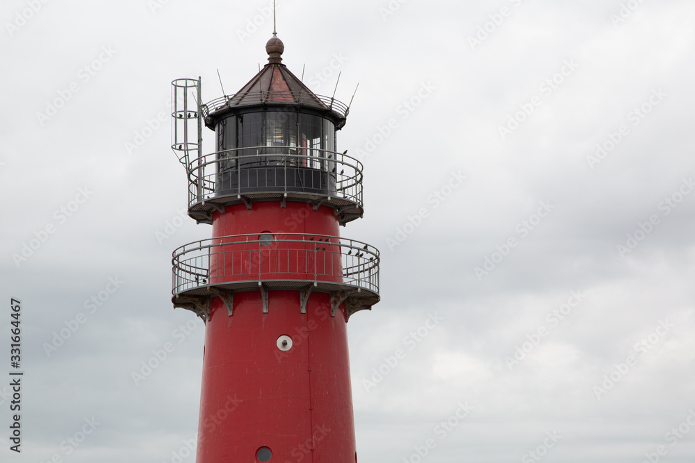 Historic red lighthouse on the North Sea coast in Germany