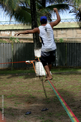 young girl doing slegline sports photo