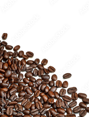 Scattered roasted coffee beans isolated on white background