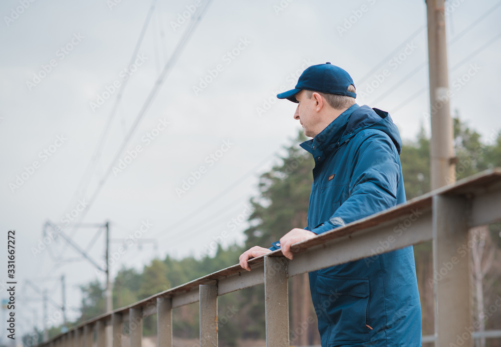 Senior man thinking about his life on Railway, Mature man psychology 