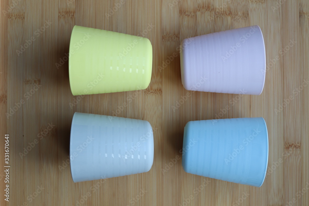 Obraz premium pale coloured plastic cup beakers
