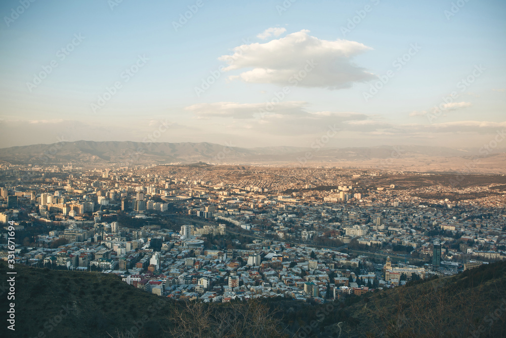 Beautiful panoramic view of Tbilisi, Georgia. The city near the mountains against the sky with clouds.