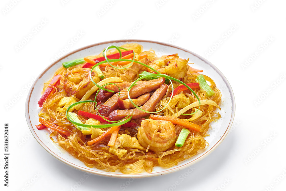 Singapore Mei Fun in plate isolated on white background. Singapore Noodles is chinese cuisine dish with rice noodles, prawns, char siu pork, carrot, red onion, napa cabbage. Chinese food. Singapore Mei Fun in plate isolated on white background. Singapore Noodles is chinese cuisine dish with rice noodles, prawns, char siu pork, carrot, red onion, napa cabbage. Chinese food.