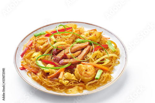 Singapore Mei Fun in plate isolated on white background. Singapore Noodles is chinese cuisine dish with rice noodles  prawns  char siu pork  carrot  red onion  napa cabbage. Chinese food.