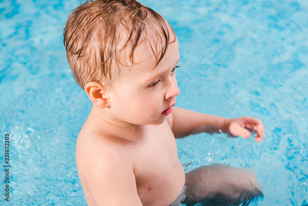 selective focus of cute toddler boy in swimming pool selective focus of cute toddler boy in swimming pool