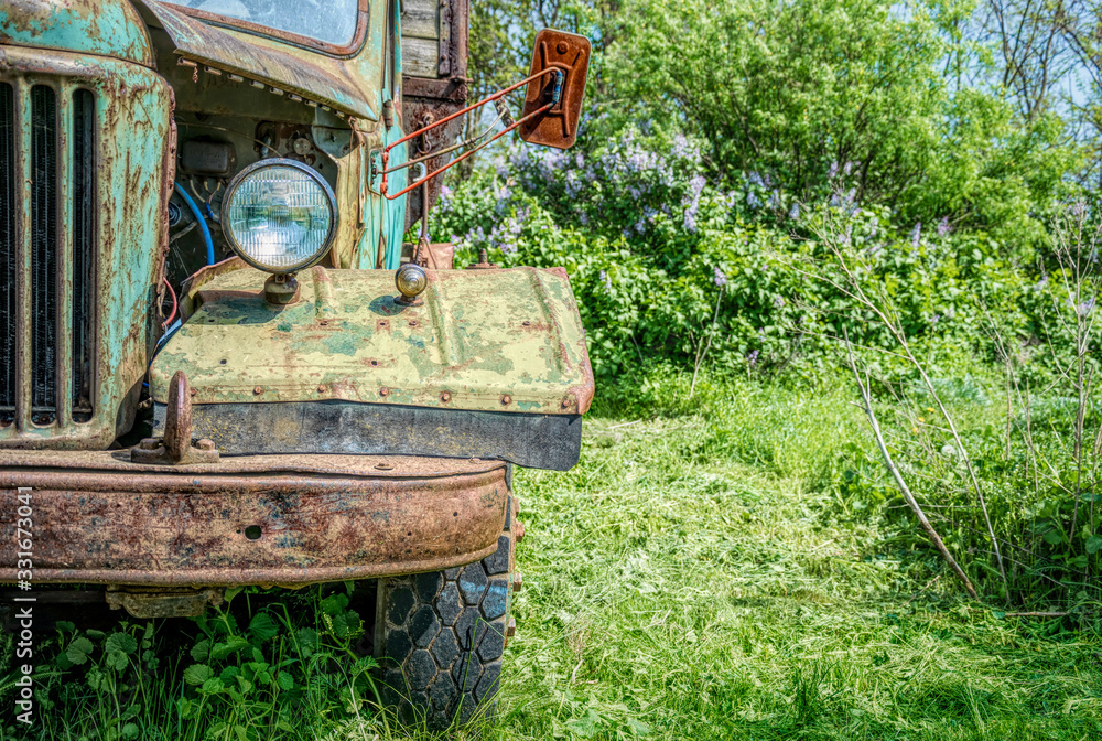 Old rusty truck on the green spring rural field Old rusty truck on the green spring rural field