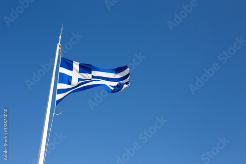 Greece flag flies against the sky