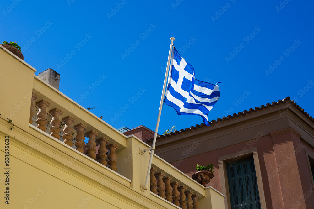 Greece flag flies against the sky