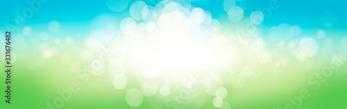 A blurred fresh spring, summer blue and green abstract banner background with bokeh glow.