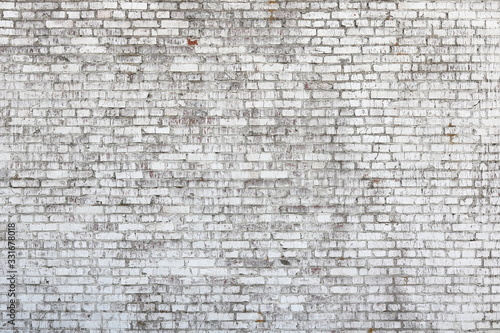 Old wall made of red brick, painted white in loft style for modern designer interior of room, bar or restaurant