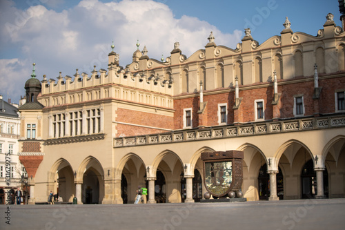 Piggy bank on the background of the Cloth Hall. Main Market Square in Krakow
