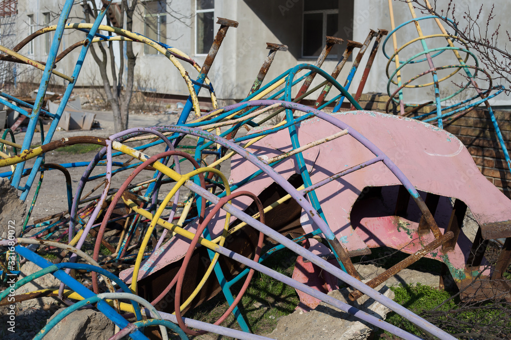 Ruined old children's playground on the street. Ruined old children's playground on the street.