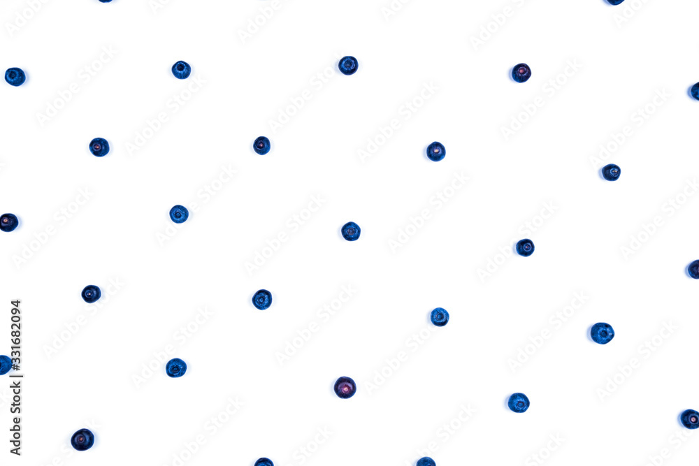 White background with blueberries laid out in a pattern.
