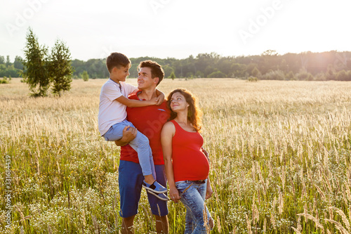 A happy couple is posing in the wheat field
