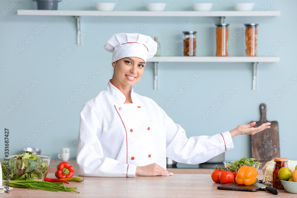 Beautiful female chef in kitchen Beautiful female chef in kitchen
