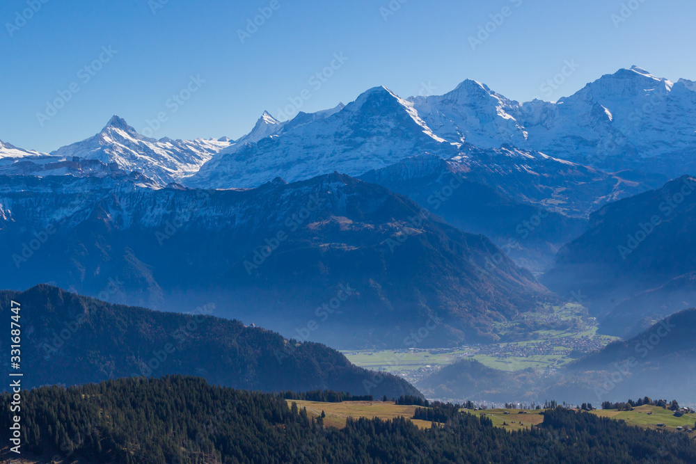 snowcapped Eiger, Moench and Jungfrau mountains with blue sky