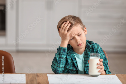 Little boy with dairy allergy in kitchen