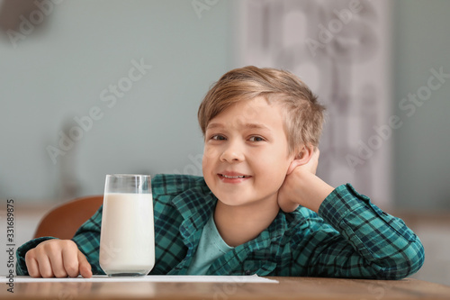 Little boy with milk in kit...