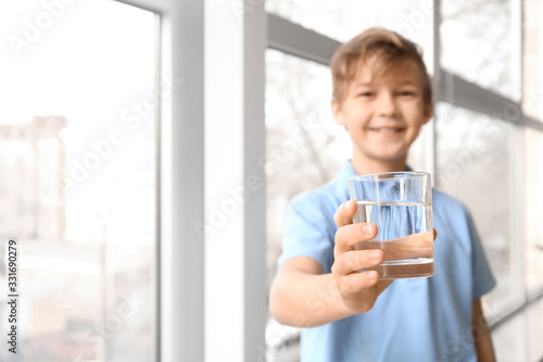 Cute little boy drinking wa...
