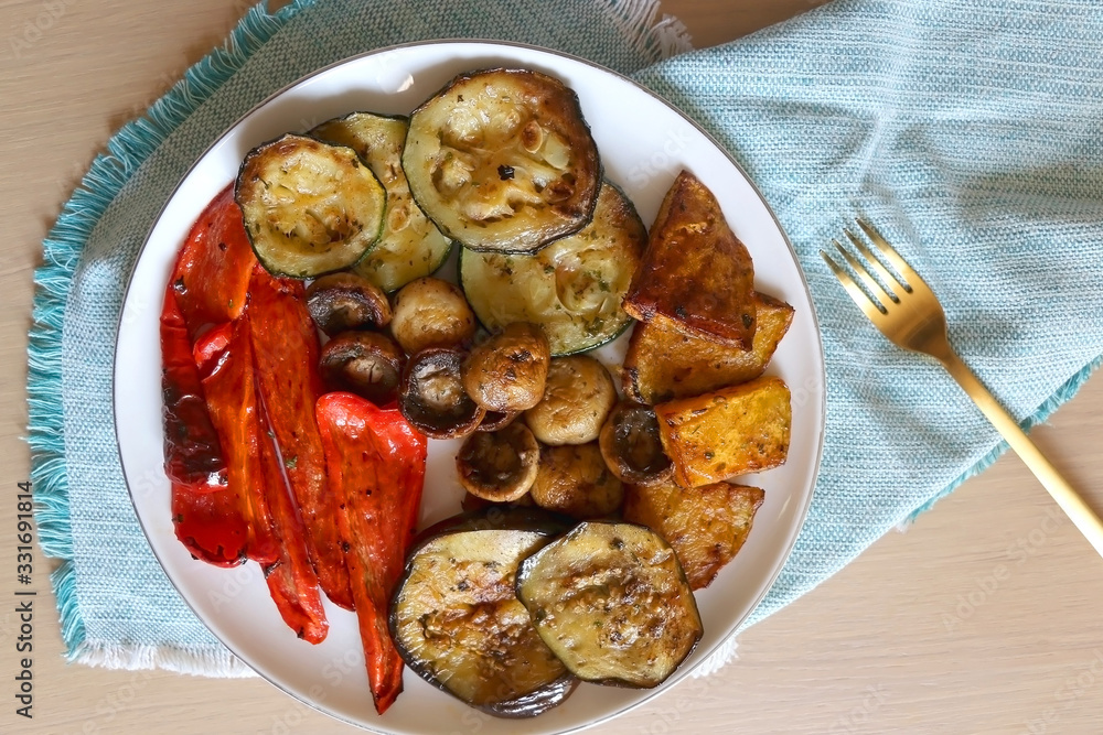 Plate of grilled portobello mushrooms and seasonal vegetables. Top view. Plate of grilled portobello mushrooms and seasonal vegetables. Top view.