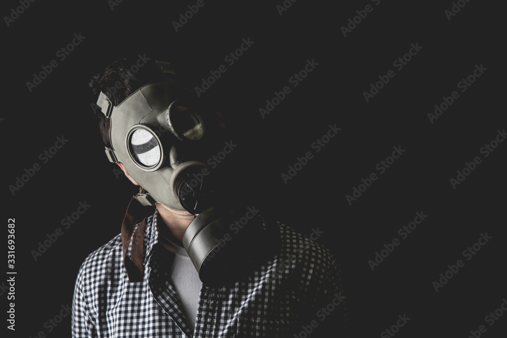 Man in the old military gas mask, escaping the reality of the duties of managerial life. Man in the old military gas mask, escaping the reality of the duties of managerial life.