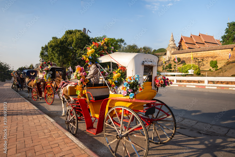 The horse carriage in Lampang at Wat Phra That Lampang Luang , Lampang province in LAMPANG THAILAND.