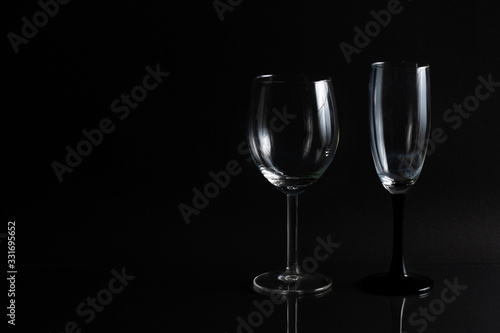 Empty glass for wine on a black background with space for text