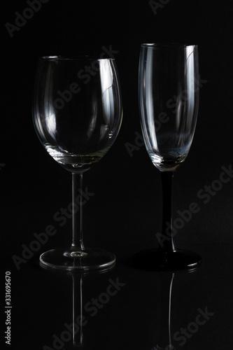 Two empty glasses for wine on a black background