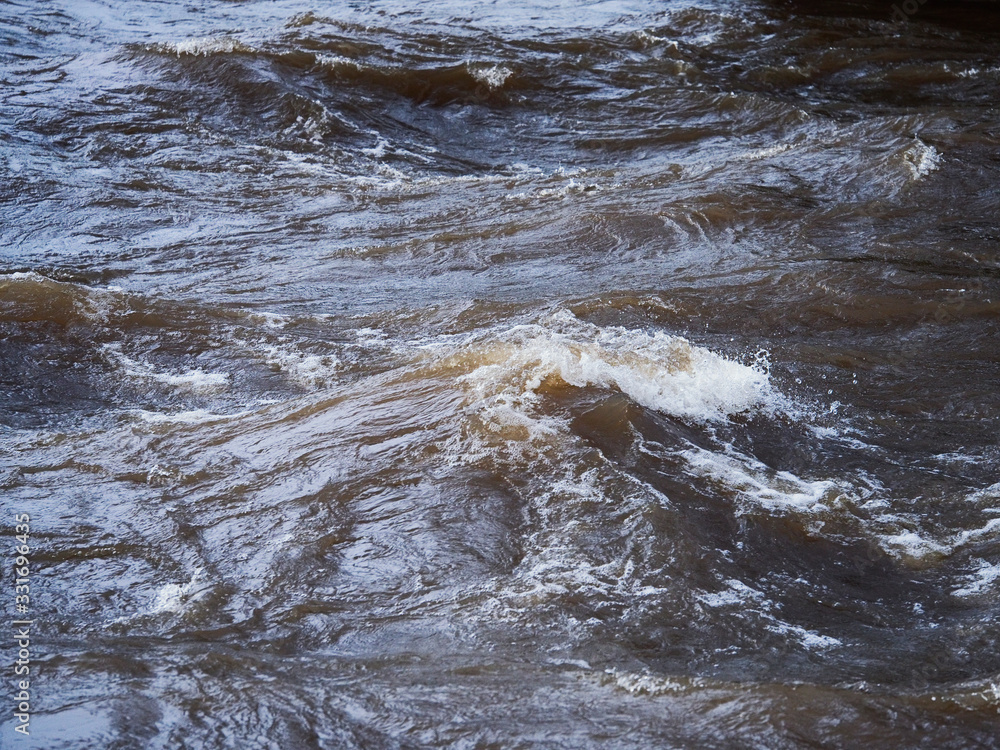 Waves and plashes of water in river, Concept flood, power of nature.