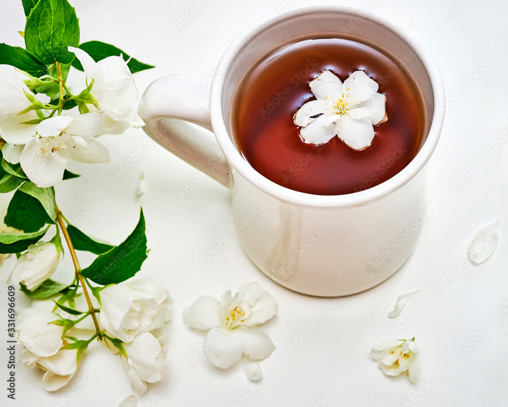 Tea cup with Jasmine flowers on white background