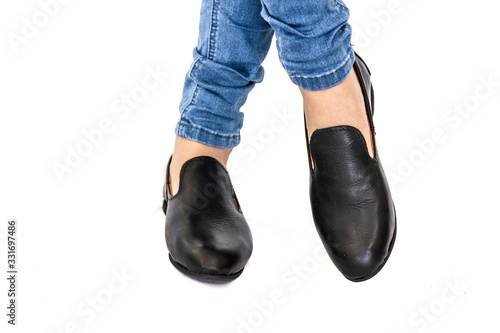 Female |Black leather shoes isolated against a white backdrop