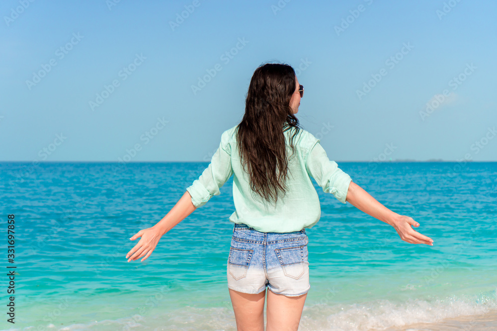 Woman laying on the beach enjoying summer holidays looking at the sea Woman laying on the beach enjoying summer holidays looking at the sea
