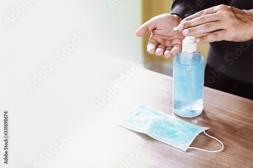 washing hands with alcohol-based sanitizer gel, together with preparing medical masks, to protect personal hygiene, prevent germs and avoid coronavirus outbreak